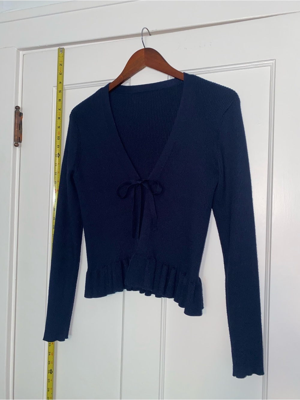 Navy cardigan with ruffles and bow tie